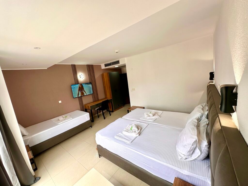 Superior room interior with a bed, desk and air conditioner