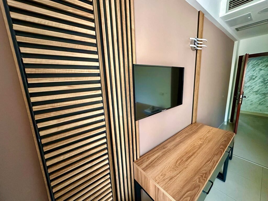 Television and desk beside a wardrobe in a Standard room